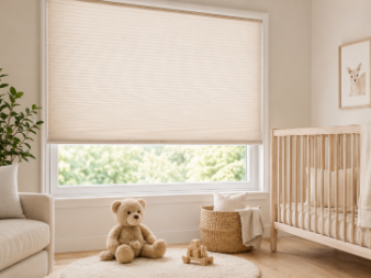Cordless honeycomb blind fitted in a nursery beside a cot.