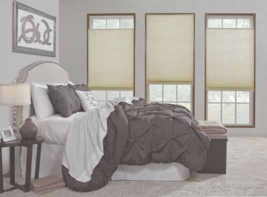 Top-down bottom-up honeycomb blinds fitted to bedroom windows for privacy and natural light.